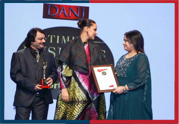 Dr. Shriyans Jain getting Times Business Award from Neha Dhupia